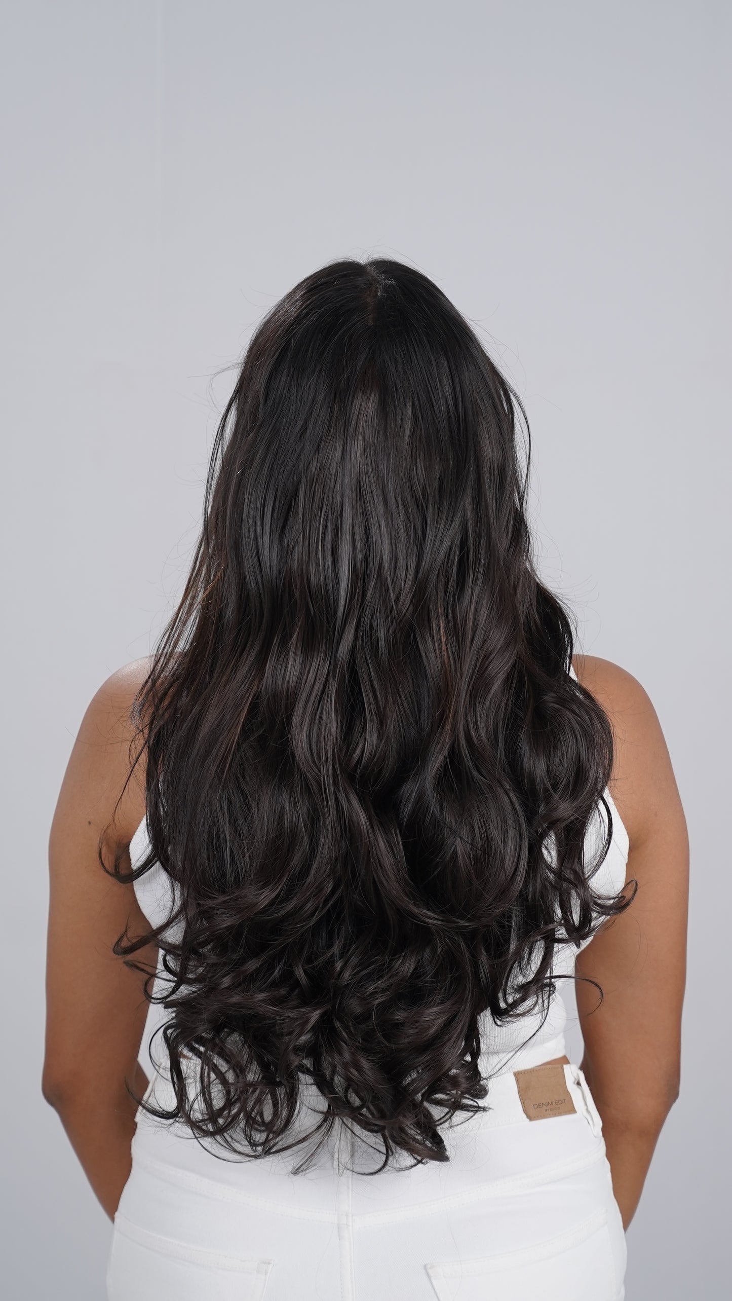 Model wearing Curly Total Volume extensions with full curls