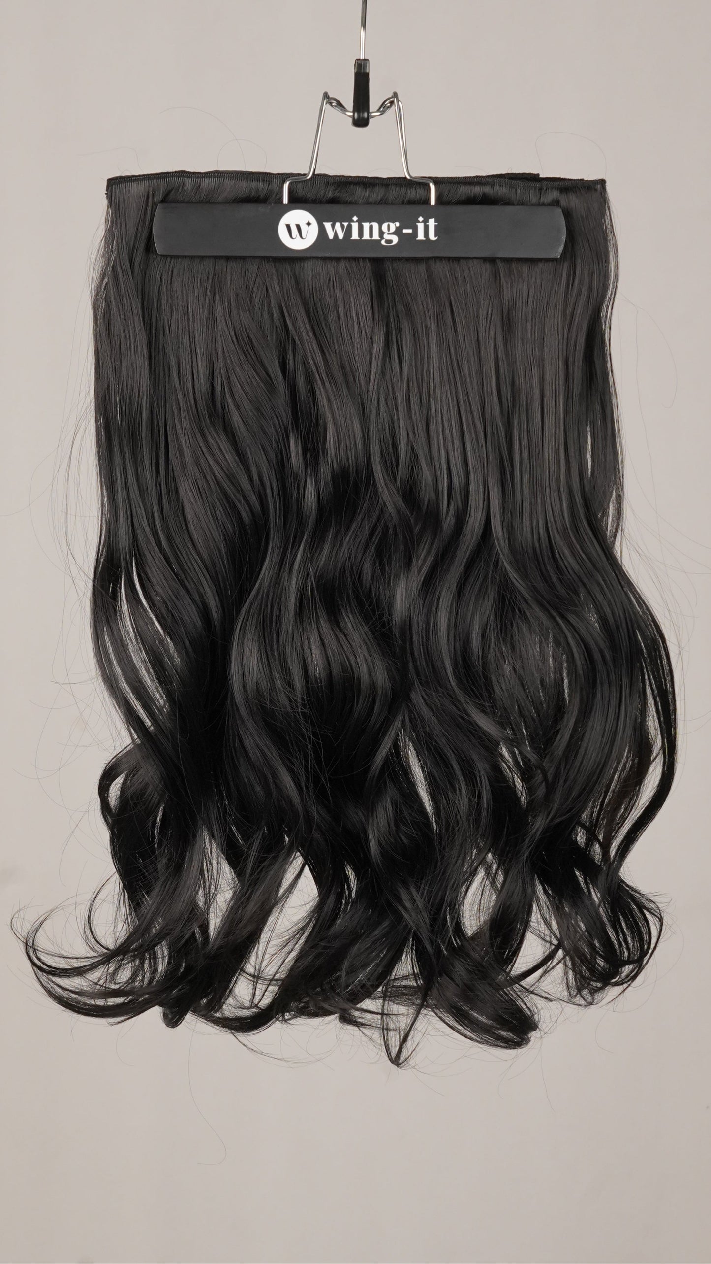 Natural Wavy Total Volume clip-in extensions in black, five-piece