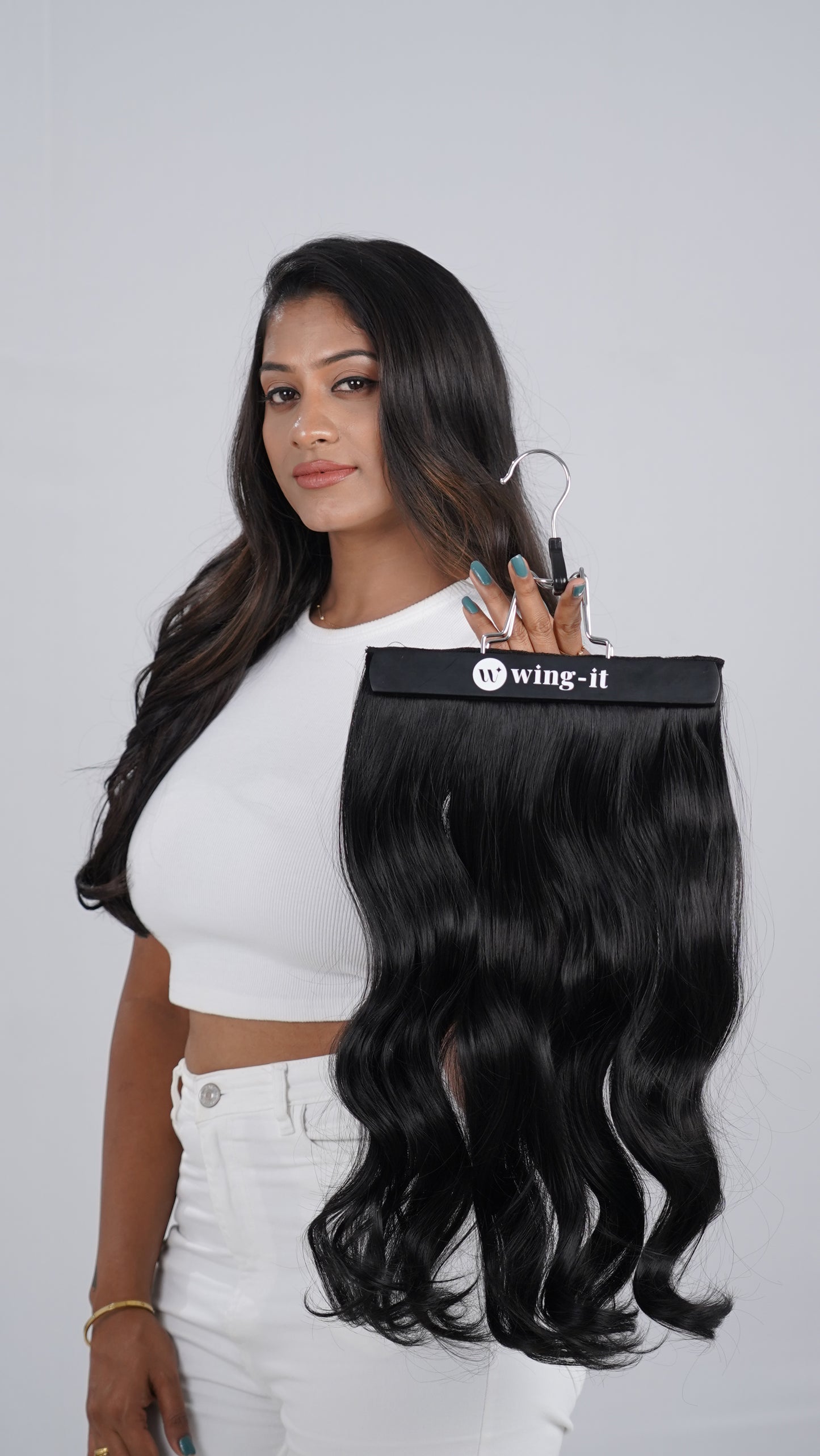 Model holding Curly Quick Volume clip-in hair extension, one-piece
