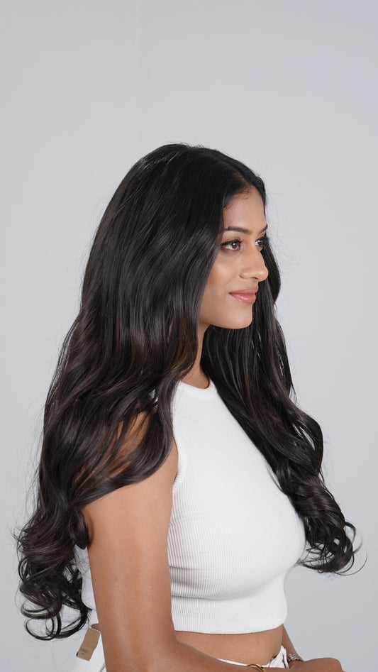 Model wearing Curly Total Volume extensions with full curls
